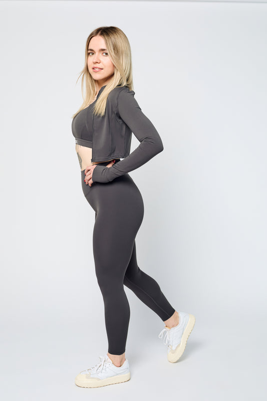Woman wearing ICONIC Sculpting Leggings and jacket in gray