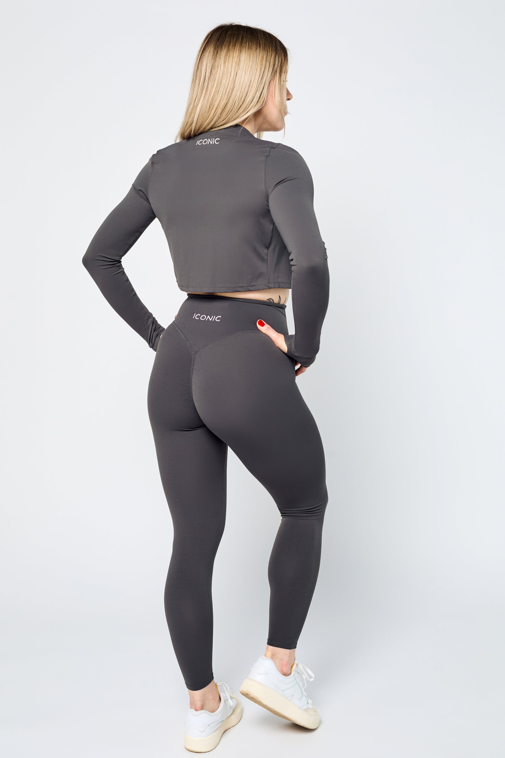 Woman wearing ICONIC Sculpting Leggings and jacket in gray