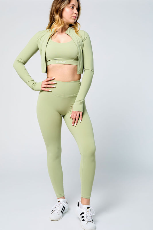 Woman wearing ICONIC Sculpting Leggings in green pistachio