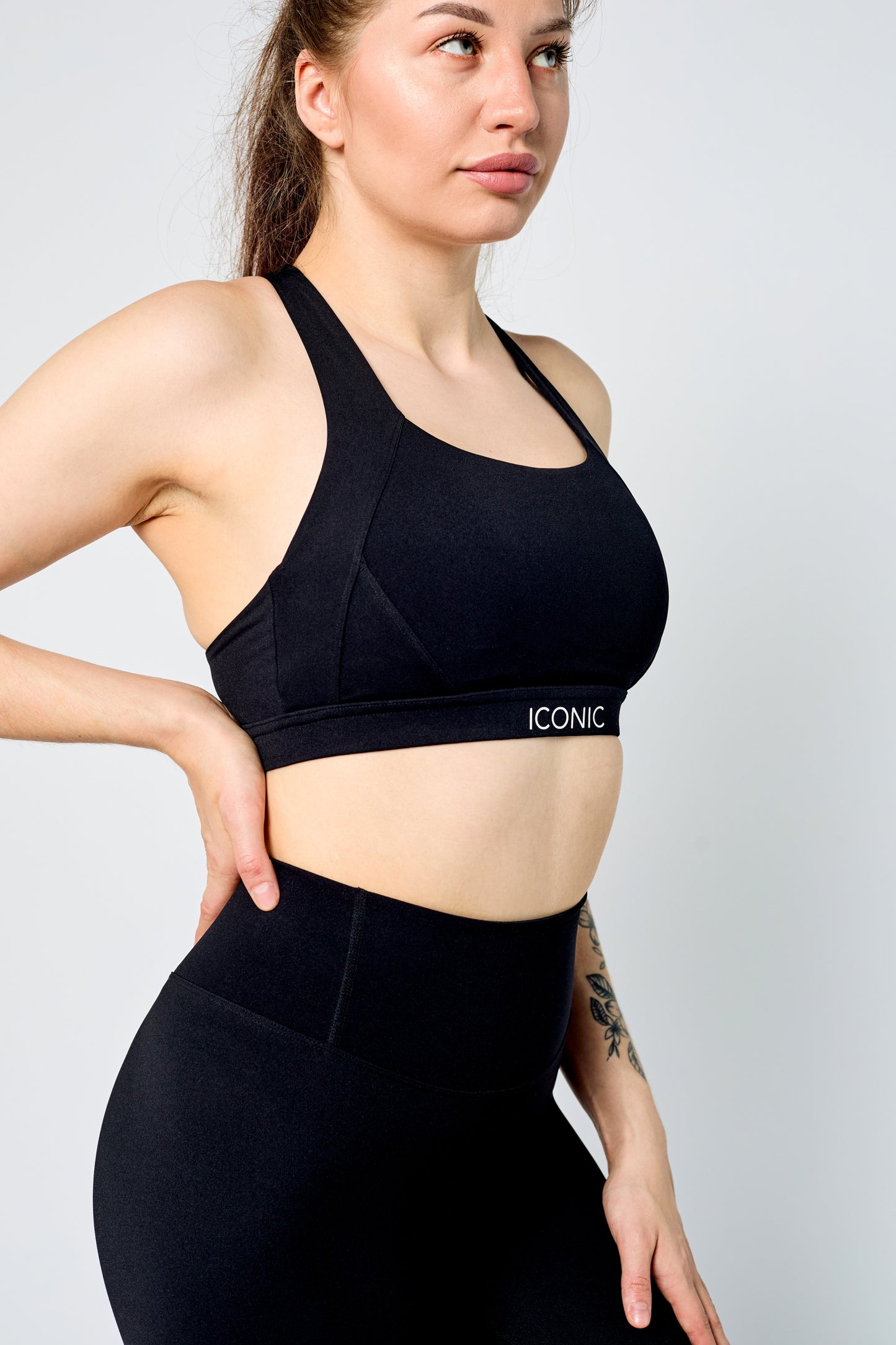 Woman wearing ICONIC Sculpting top in black