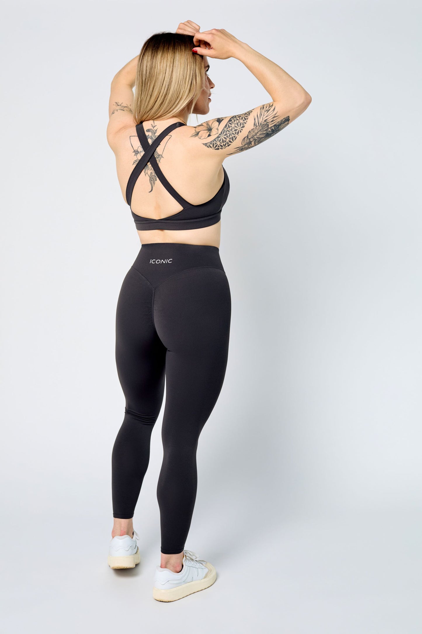 Woman wearing ICONIC Sculpting Leggings in gray
