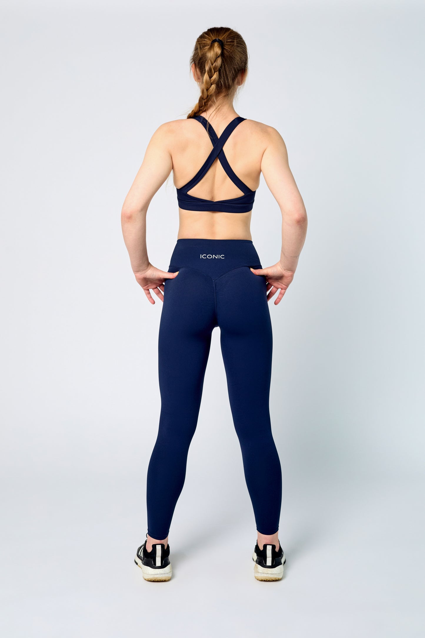 Woman wearing ICONIC Sculpting Leggings in navy
