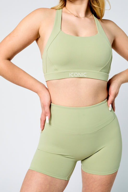 Woman wearing ICONIC Sculpting top in green pistachio