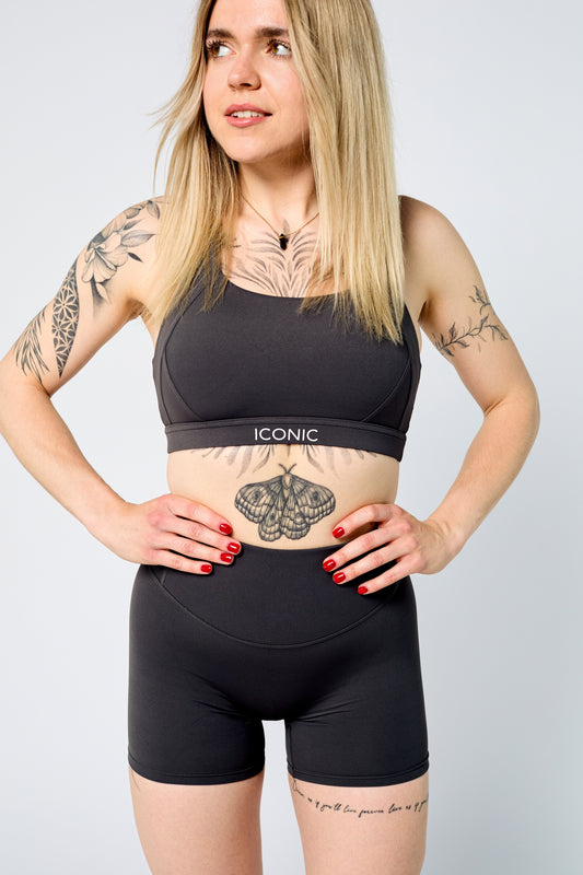 Woman wearing ICONIC Sculpting top in gray