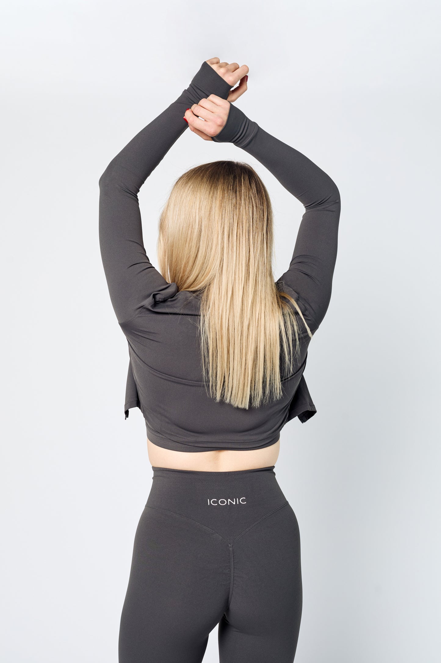 Woman wearing ICONIC Sculpting Leggings and jacket in gray